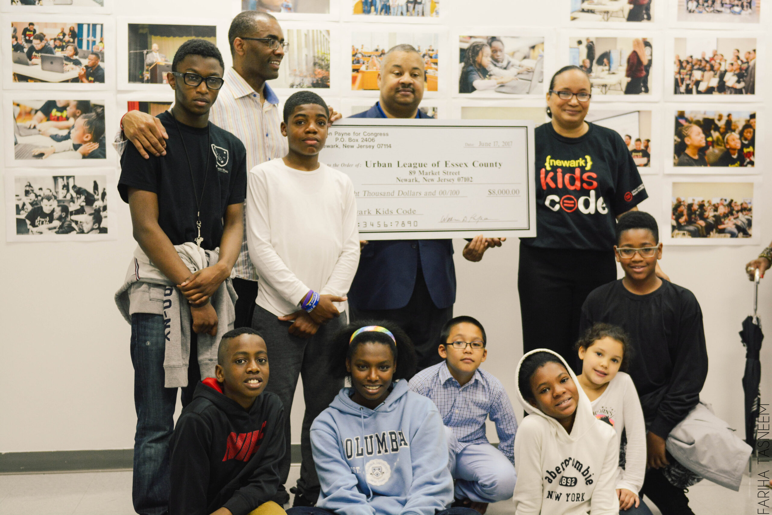 ULEC director and students receiving check donation